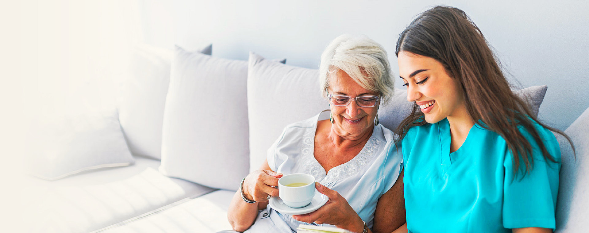 caregiver and a senior woman chilling on the living room