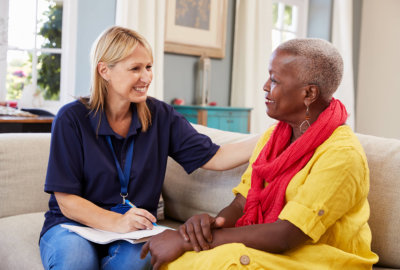 caregiver and a senior woman having a conversation