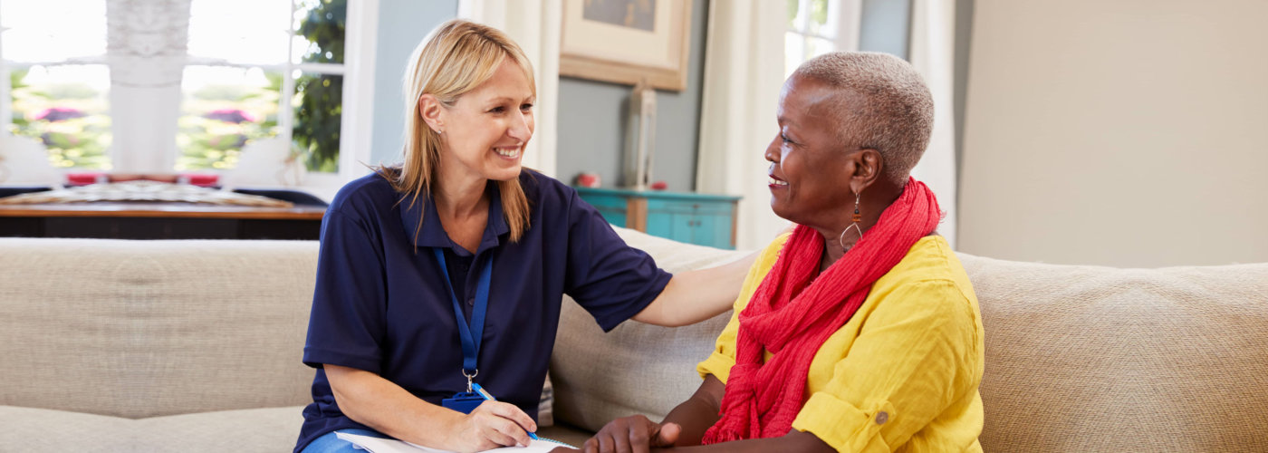 caregiver and a senior woman having a conversation