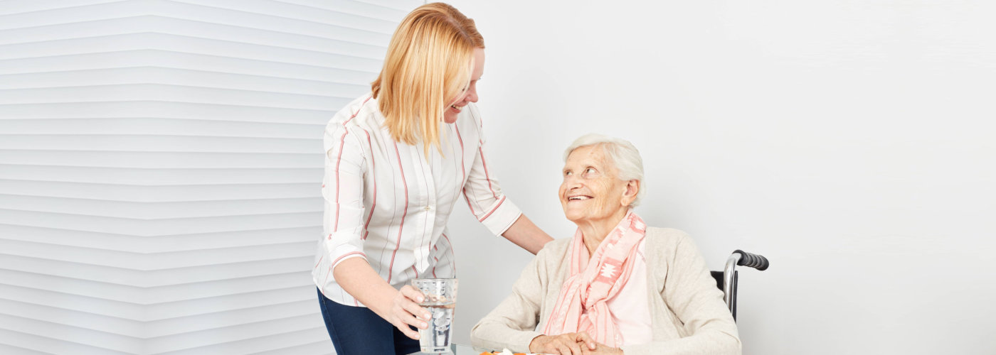 caregiver serving her patient her meal